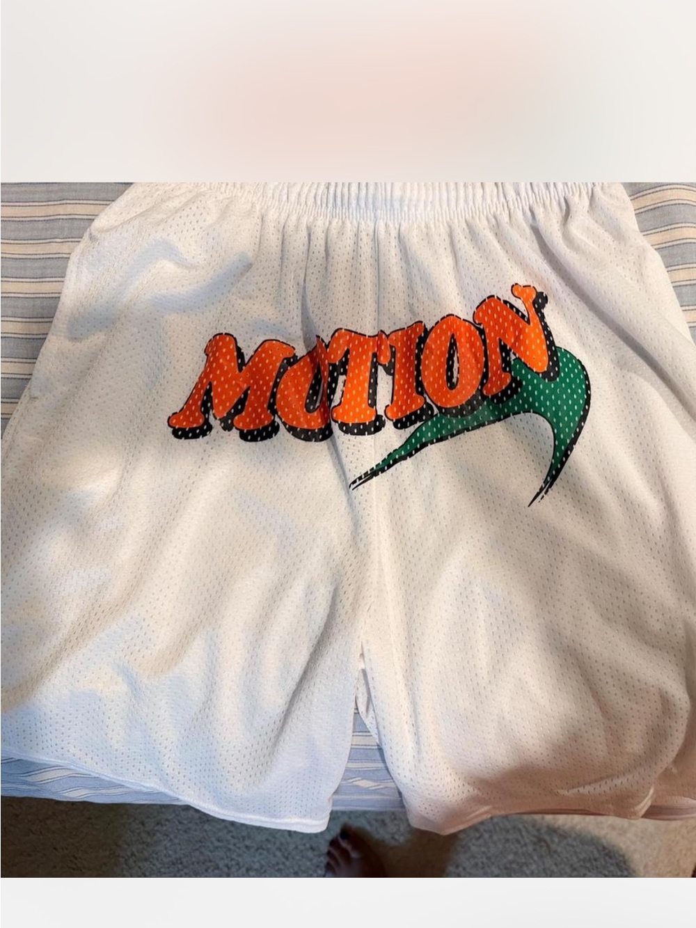 Russell Athletic White Mesh Shorts with Orange 'MOTION' Graphic and Green Swoosh